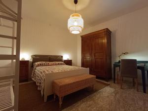 a bedroom with a bed and a table and a chair at CASA TARTARUGA in La Spezia