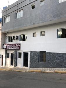 a building with a sign on the side of it at Pousadaa São João 144 in Aparecida