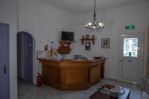 a kitchen with a wooden island in a room at Soula Rooms Tinos in Tinos