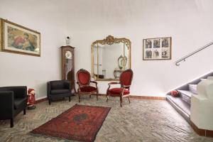 a living room with a table and chairs and a mirror at Affittacamere San Teodoro in Albenga