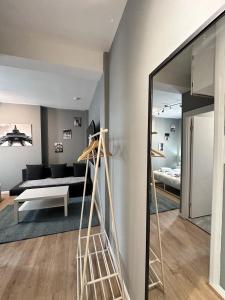 a room with a ladder and a living room at Light Budget Studio Apartment on Edgware Road, Central London in London