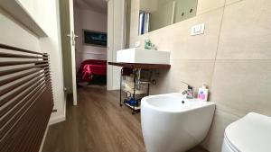 a bathroom with a sink and a toilet and a mirror at A34 - Ancona, delizioso bilocale in centro in Ancona