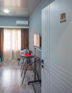 a room with a table and a dining room at Hotel Homeland in Batumi