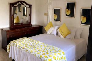 a bedroom with a large bed with a mirror at Mandeville Chateau in Mandeville