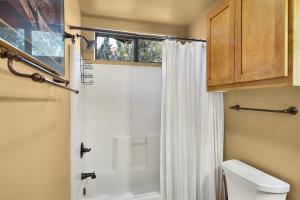 a bathroom with a shower with a white shower curtain at Mammoth Rock Retreat Villa-Sleeps 4 in Sedona