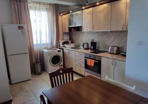a small kitchen with a table and a refrigerator at Family 2 bed Apartment in Bansko in Bansko