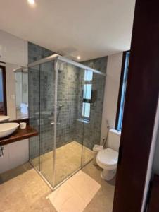 a bathroom with a shower and a toilet and a sink at Chalé Antúrios - Lavras Novas in Lavras Novas +21 photos