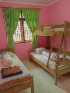 two bunk beds in a room with pink walls at Villa family Montana 3 in Cicadas +12 photos