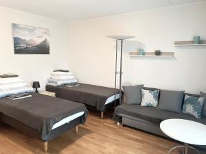 a living room with two beds and a couch at RANTA in Tampere