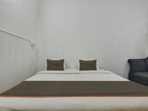 a bed with two pillows on it in a room at Collection O Goa Savera Holiday Homes in Nerul