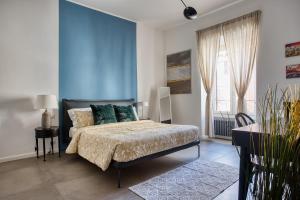 a bedroom with a bed and a blue wall at Clausim Domus: new brightful flat next to the Vatican in Rome