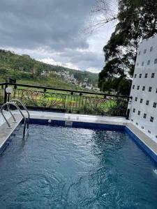 a large swimming pool in front of a building at Puncak villa in Puncak