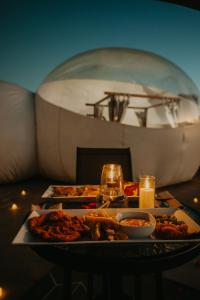 a table with a plate of food and a boat at The Bubble Valley in Piet Retief