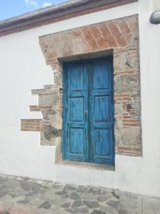 a blue door on the side of a building at Blue Moon Hostel in Antigua Guatemala