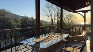 a table and chairs on a balcony with a view at Villa Bellissimo in Skala Potamias