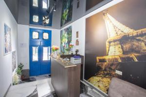 a room with a painting of the eiffel tower at Hotel Homeland in Batumi +65 photos