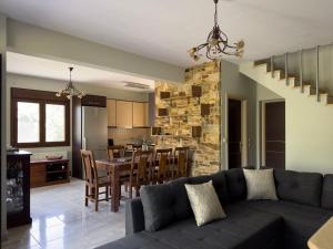 a living room and kitchen with a couch and a table at Villa Bellissimo in Skala Potamias