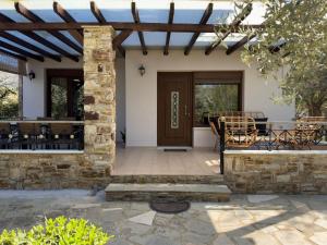 a patio with a wooden door and a table and chairs at Villa Bellissimo in Skala Potamias