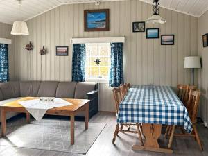 a living room with a table and a couch at 6 person holiday home in Storfosna-By Traum in Sletta