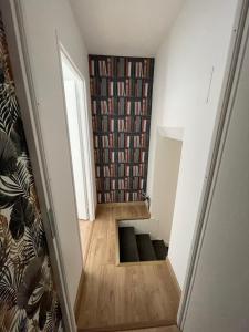 a hallway with a book shelf filled with books at Le Clos des Cadots in Chaintré