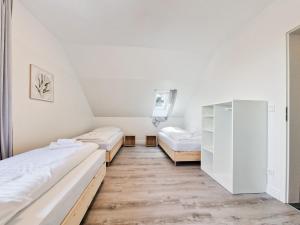 Duas camas num quarto com pisos em madeira em RAJ Living - 4 Room Apartments - 30 Min Messe DUS em Neuss