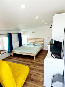 a bedroom with a bed and a flat screen tv at Władysławowska 36 - domki i pokoje gościnne in Władysławowo