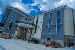 a building with cars parked in front of it at MUNA SUITES in Owerri