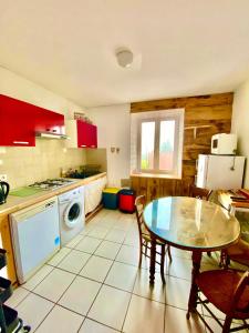 a kitchen with a table and a stove top oven at Gîte Béthel in Lachamp-Raphaël