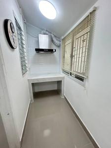 a hallway with a table and a clock and a window at Townhouse nearby Klong Dao beach in Ban Mo Nae +22 photos