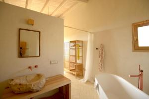 a bathroom with a tub and a sink and a mirror at Casa Imayah charming B&B in Noto +75 photos