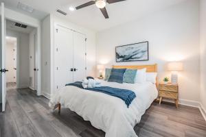 a bedroom with a large bed and a ceiling fan at Amalie Arena, Raymond James, Armature Works in Tampa