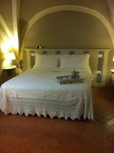 a white bed with a tray on top of it at Residenza Gatteschi in Pistoia