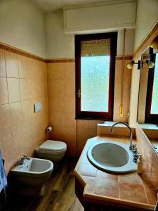 a bathroom with a sink and a toilet at Guest House Fantaccini in Pelago