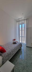 a bedroom with a bed with a chair on it at La casa di Alessandro in Monopoli