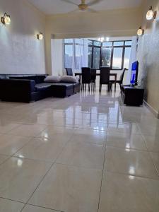 a large living room with a couch and a table at Seaput Srisayang in Batu Ferringhi