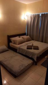 two twin beds in a room with at Seaput Srisayang in Batu Ferringhi +28 photos