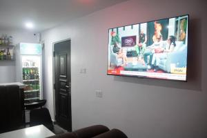 a flat screen tv hanging on a wall at Baseville Hotel in Lagos