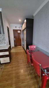 a room with a red ping pong table and chairs at Orbi Residence Volna,Batumi apart in Batumi