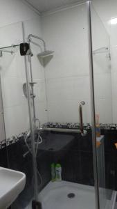 a bathroom with a shower with a glass door at Orbi Residence Volna,Batumi apart in Batumi