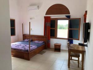 Ένα ή περισσότερα κρεβάτια σε δωμάτιο στο Residence Massena, Grand-Popo in Benin