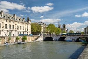 a bridge over a river in a city with buildings at Quartier Notre Dame in Paris