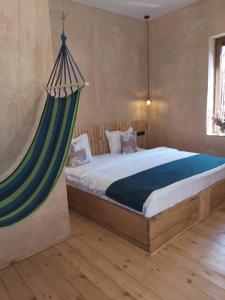 a bedroom with a bed with a hammock above it at Valley Park Dilijan in Dilijan