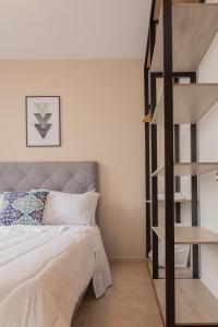 a bedroom with a bed and a spiral staircase at Piso 10 - Amarilo Villavicencio in Villavicencio