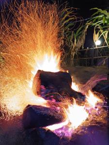 a fire pit filled with sparks at night at Evara by The Offbeat Crew in Idukki