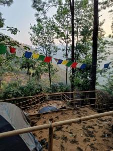 a line of prayer flags in a forest at Evara by The Offbeat Crew in Idukki