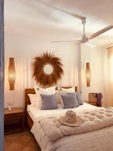 a bedroom with a large bed with a hat on it at Attico fronte mare Espardell19 Es Pujols in Es Pujols