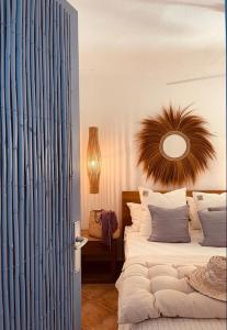 a bedroom with a large bed and a mirror at Attico fronte mare Espardell19 Es Pujols in Es Pujols