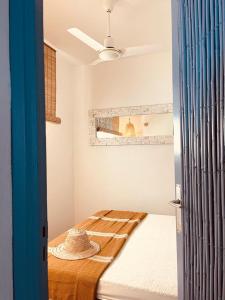 a room with a bed with a hat on it at Attico fronte mare Espardell19 Es Pujols in Es Pujols +9 photos