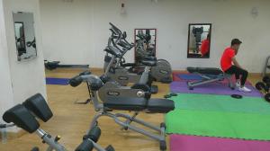 a person in a gym with exercise equipment at Ruby Star Studio Apratment in Dubai