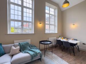 a living room with a couch and a table at Exceptional Holiday Home 7 in Pickering with Hot Tub in Pickering